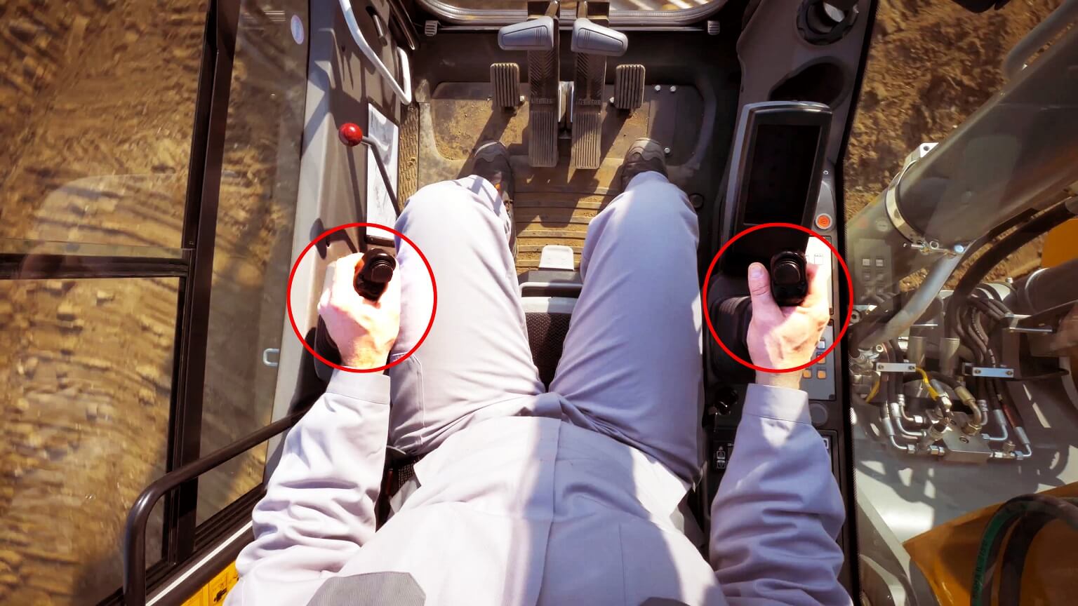 Excavator interior showing excavation controllers